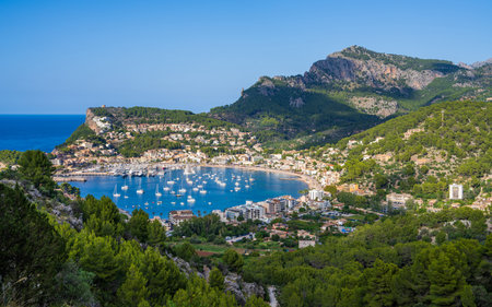 Beautiful view of the harbor with many yachts, ships in the Balearic village of Puerto de Soller, a popular holiday destination in Mallorca. Sunny day, vacation time.の写真素材
