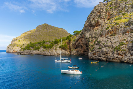 Sa Calobra. Mallorca, Spain, October 3rd, 2023. Picturesque seascape. Cove with blue sea, white yachts among mountains of Mallorca on coast of Sa Calobra, Mallorca, Spain, Balearic Islandの写真素材
