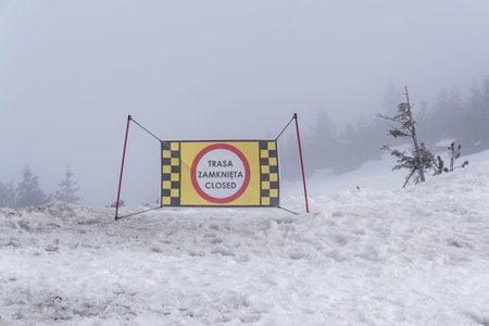 Closed is a prohibition sign. Ski resort, wet snow, ice, heavy fog, very poor visibility. The ski...