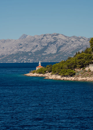 Amazing coastline. Mountains covered with greenery. Blue, transparent sea. Lonely lighthouse....