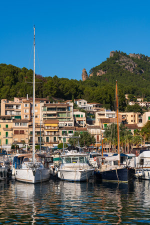Scenic view icturesque harbor Port de Soller, Mallorca, with elegant yachts moored in calm Mediterranean waters. Perfect blend of maritime charm and coastal beauty.の写真素材