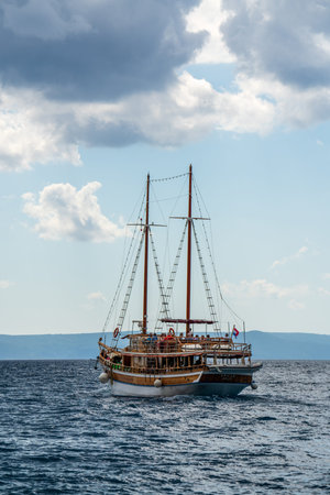 Croatia. September 17, 2022. Tourist wooden ship sailing on calm sea with group of tourists on...