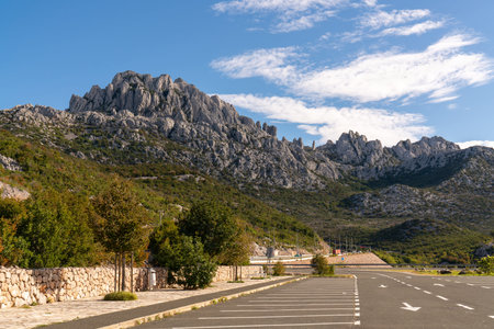 asphalt highway, cars rush to leave. green mountain natural landscape under blue sky. Croatian...