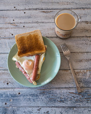 fried egg, sausage, coffee, toast bread, breakfast, food, food snack on the table, food background, rustic top viewの写真素材
