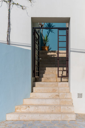 Staircase of stone steps to a small house, in the distance there is a palm tree. Balearic Islands, Mallorcaの写真素材
