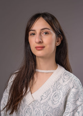 Portrait of a young woman, close-up, on a gray background