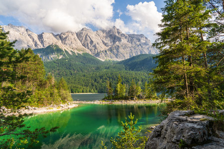Eibsee lake with clear turquoise water, surrounded by Bavarian Alps near Zugspitze mountain,...