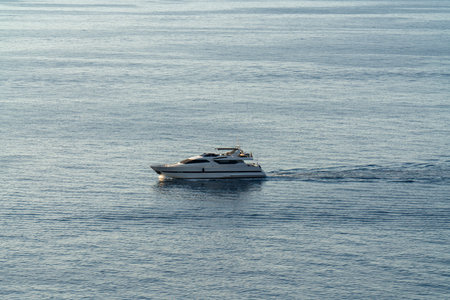 Huge elegant motor yacht sails in open sea, symbolizing freedom, pursuit of dreams. Suitable for themes of success, sea travel.の写真素材