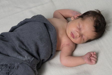 Newborn baby in the first days of life. Cute little newborn boy. Close up