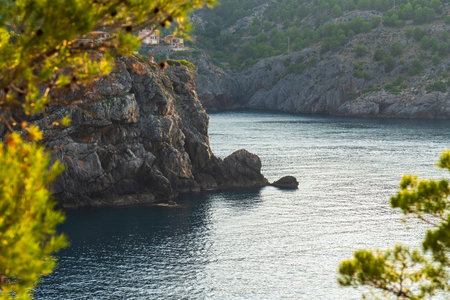 Rocky, steep coastline Port de Soller on island Mallorca. Waters Mediterranean Sea wash shore....