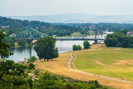 Landmark steel bridge spanning Elbe River in Dresden, Germany. Famous architectural structure known for its scenic views and historical significance. Popular destination for visitors.の写真素材