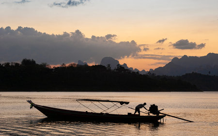 fisherman in boat in khao sok