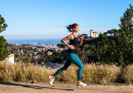 woman running with barcelona view as backgroundの写真素材