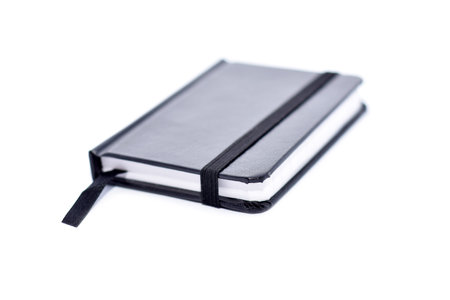 Small black notebook isolated on white