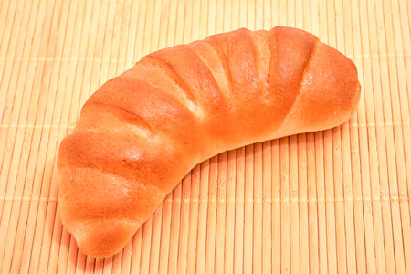Fresh croissant with chocolate on wood background