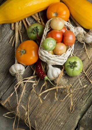Rural still life with vegetables on wooden tableの写真素材