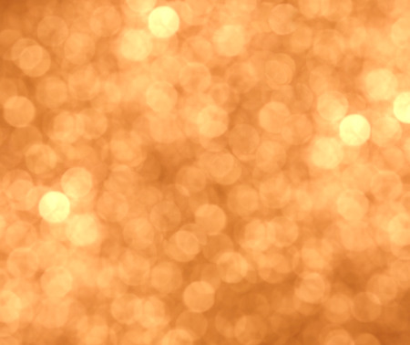 Festive golden background with light. Bokeh and glowの写真素材