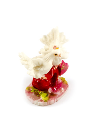 Figurine of two white doves with heart and an inscription love on a white backgroundの写真素材