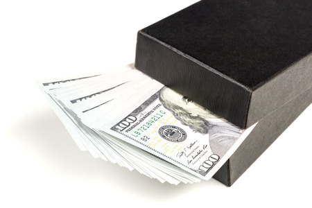 Black box sticks out bundle of hundred dollar bills isolated on white backgroundの写真素材
