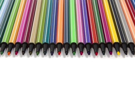 Row of colored felt tip pens open isolated on whiteの写真素材