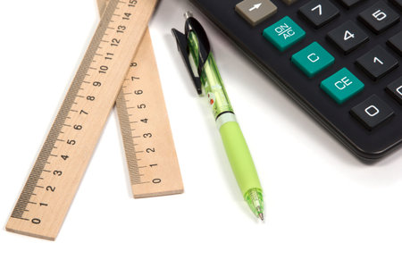 Calculator with pen and two ruler isolated on white