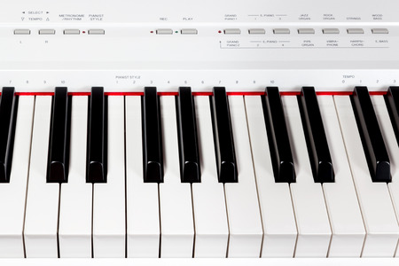Keys of white electric music synthesizer with a set of buttonsの写真素材