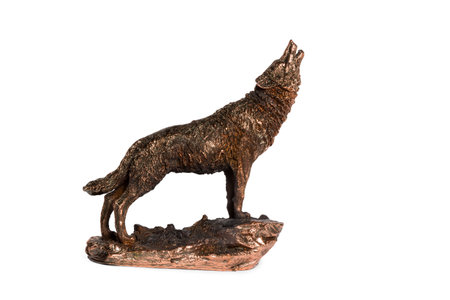 Bronze statue of a wolf howling at the stand side view isolated on white backgroundの写真素材