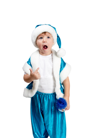 Kid boy in blue kostyumesanta points a finger at his open mouth isolated on white backgroundの写真素材