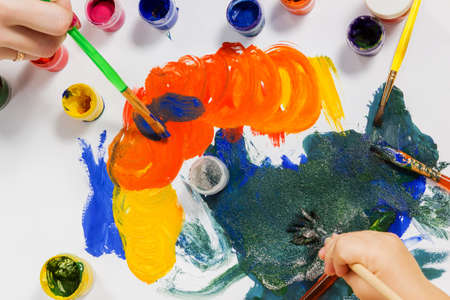 Women and children hands paint brushes abstract drawingの写真素材