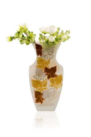 Artificial bouquet of white peonies in a glass vase isolated on white backgroundの写真素材