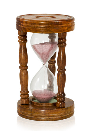 Vintage wooden hourglass with pink sand isolated on white backgroundの写真素材