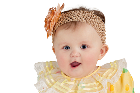 Closeup portrait of little girl with a patch with flower on his head isolated on white backgroundの写真素材