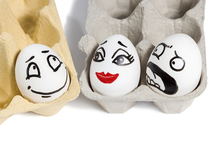 Scene from eggs with faces which shows love infidelity and jealousy isolated on white backgroundの写真素材