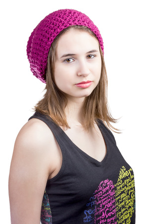 Portrait of a beautiful girl in crimson hat with brown eyes staring sideways to the camera isolated on white backgroundの写真素材