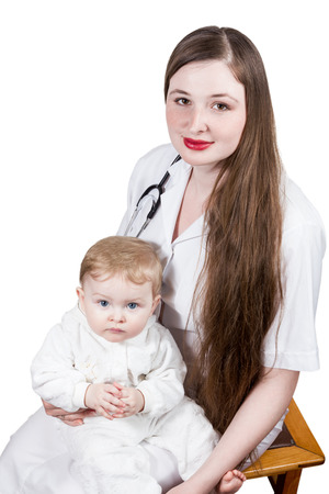 Woman pediatrician is holding a toddler isolated on a white backgroundの写真素材