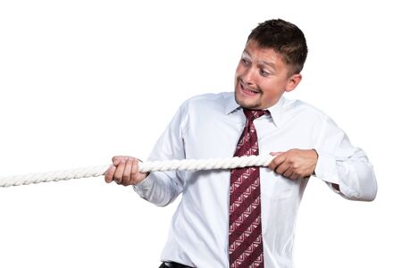 A man in a white shirt and tie himself emotionally drawn to a rope isolated on white backgroundの写真素材