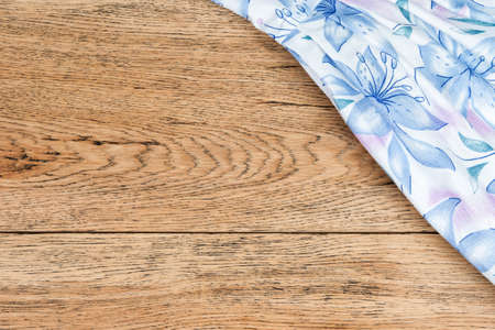 Old vintage board with a cotton cloth with flowers in the corner as a backgroundの写真素材