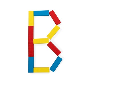 Capital letter B made up of different color wooden rectangular blocks isolated on a white backgroundの写真素材