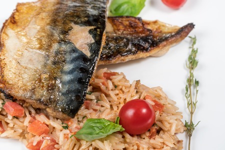 Baked fish mackerel with rice and cherry tomatoesの写真素材