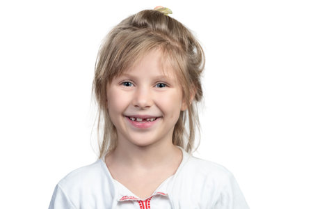 Portrait of a beautiful smiling child girl with no front teeth isolated on white background