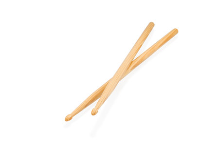 Two wooden drum sticks lying on each other isolated on white backgroundの写真素材