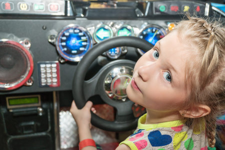 Portrait of a girl sitting behind the wheel in a slot machine, close-up
