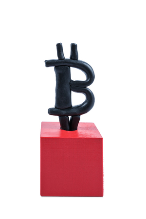 Plasticine bitcoin sign on a red cube isolated on a white backgroundの写真素材
