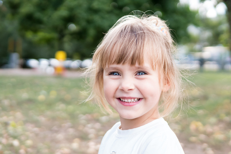 Close-up portrait of a beautiful little girl laughing happilyの写真素材