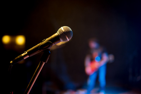 Classic microphone on the stand at a concert in the darkの写真素材