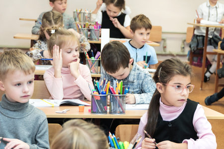 Kharkov, Ukraine - November 30, 2017: Boys and girls study at school sitting at desks. Special...