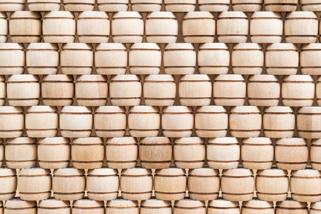 Wooden kegs of a lotto game stacked one on top of another in the form of a wallの写真素材