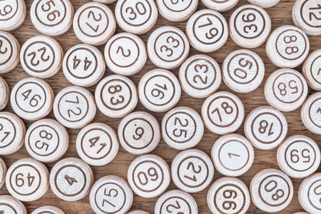 Group of kegs from a lotto game standing one next to the other on a wooden tableの写真素材