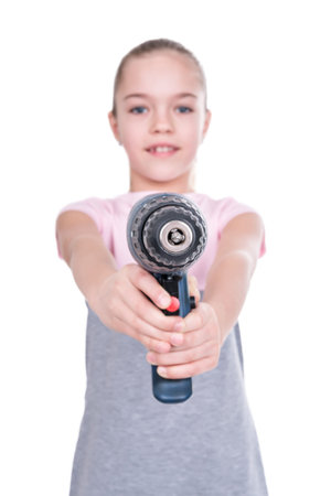 Girl aiming with a screwdriver in the camera, blurred background, isolated on a whiteの写真素材