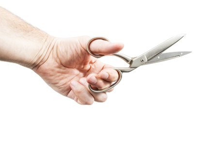 Male hand holds a large open metal scissors isolated on a white backgroundの写真素材
